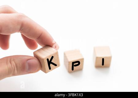 KPI, key performance indicator symbol. Concept word KPI, key performance indicator on wooden cubes on beautiful white background, copy space. Business Stock Photo
