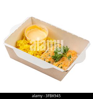 Healthy dietary salmon fish patties served with yellow turmeric rice creamy sauce and parsley in craft box isolated on white Stock Photo