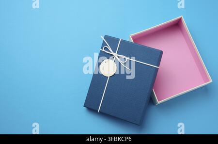 Empty open rectangular gift cardboard box on blue background, top view Stock Photo