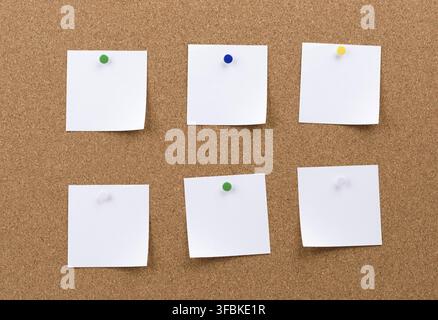 White square blank pieces of paper pinned on a cork board, copy space Stock Photo