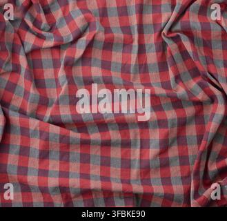 Red checkered fabric for sewing various clothes with waves, full frame Stock Photo