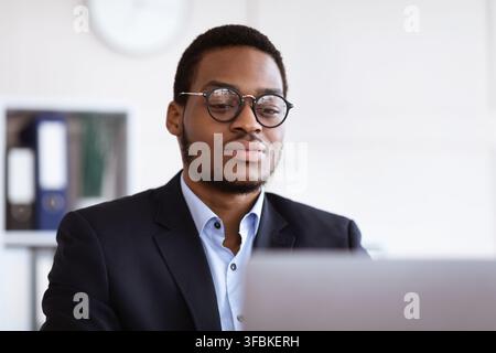 Closeup of handsome black businessman working in office Stock Photo