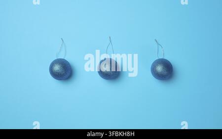 Shiny blue christmas balls for the christmas tree on a blue background. View from above Stock Photo