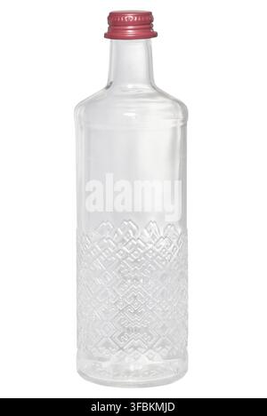 Empty transparent glass bottle with a relief pattern and a red screw cap on an isolated background. Container Stock Photo