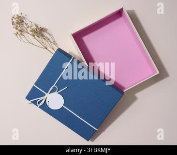 Empty open rectangular gift cardboard box on beige background, top view Stock Photo