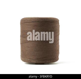 Large spool with brown cotton thread isolated on white background, close up Stock Photo