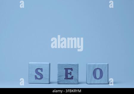 SEO inscription (search engine optimization) on wooden cubes. The concept of a set of measures for internal and external optimization to improve the p Stock Photo