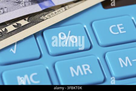 Percentage button on blue calculator, counting income, close up Stock Photo