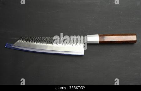 Metal kitchen knife with wooden handle on black background, close up Stock Photo