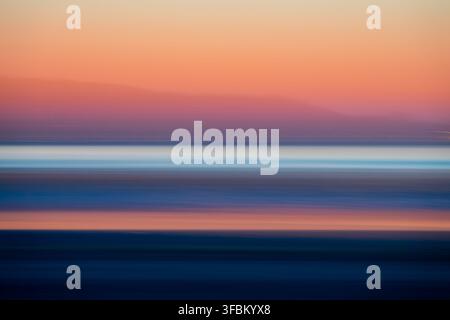Abstract beach at sunset un Brittany, France. Handmade directional blur, horizontal photo panning Stock Photo