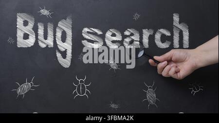 The process of finding and fixing bugs in software code. A person's hand holds a magnifying glass, using which to examine an inscription Stock Photo