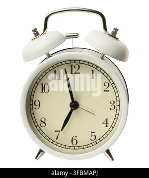 Round white metal alarm clock on isolated background Stock Photo