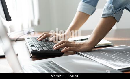 Software developer or programmer working data debugging improvement binary algorithm on desktop pc in a software develop company office Stock Photo
