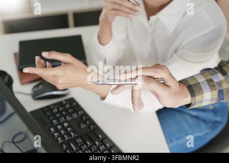 Young startup Programmers Sitting At Desks Working On Computers screen for Developing programming and coding to find solution to problem on New Applic Stock Photo