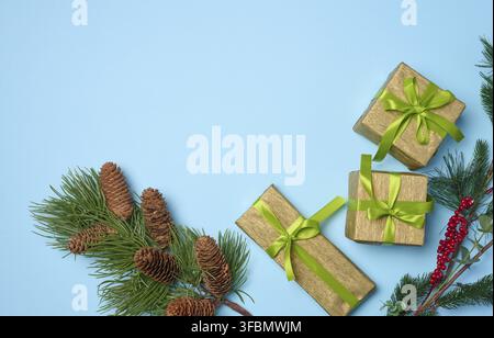 Christmas decor, gifts wrapped in yellow paper on a blue background, top view Stock Photo