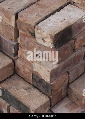 An isometric stack of various reclaimed house bricks Stock Photo