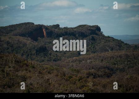 View of French Mountain featuring rugged rocky cliffs, dense dry forest vegetation, and rolling hills in Antsiranana, Diana, Madagascar. Stock Photo