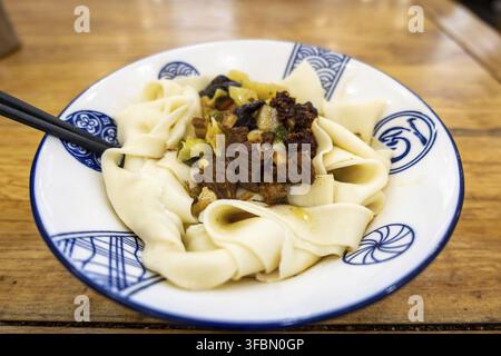 Biangbiang noodles in Xian, Shaanxi, China. Biang biang mian, Chinese Shaanxi cuisine served in Xian Stock Photo