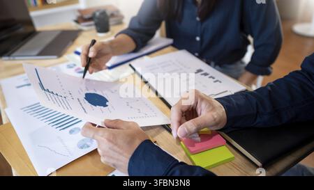 Business People Talking Discussing with coworker planning analyzing financial document data charts and graphs in Meeting and successful teamwork Conce Stock Photo