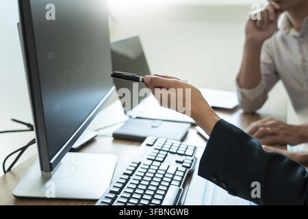 Working business man, team of broker or traders talking about forex on multiple computer screens of stock market invest trading financial graph charts Stock Photo