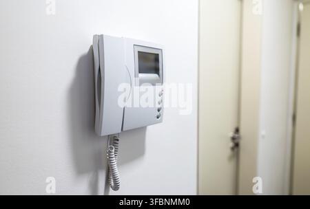 Modern Video Intercom System Mounted on white wall Stock Photo