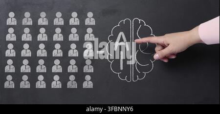 Chalk-drawn icons of human figures, an equal sign with a drawn human brain, inscription artificial intelligence. Finger points to the superiority of i Stock Photo