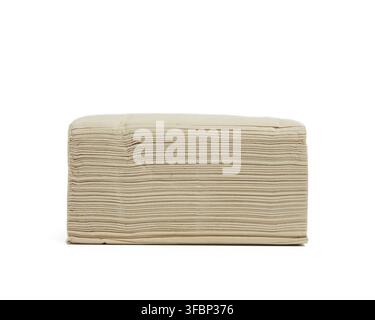 Stack of paper disposable beige folded square napkins on a white background, close up Stock Photo