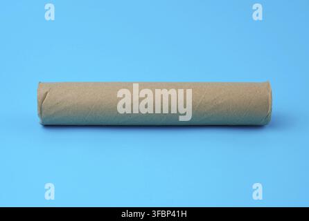 Brown paper towel from a roll of kitchen towels, object on a blue background Stock Photo