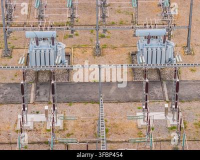 Aerial view of two high voltage power transformers and electrical switching equipment inside a power distribution substation in Valence, Auvergne-Rhon Stock Photo