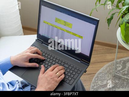 Close-Up of Businessman Hands Typing on Laptop Calculating Mortgage Amortization Table Schedule Stock Photo