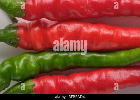 Close up red and green chili peppers in row Stock Photo