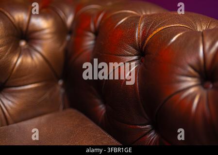 Close-up of luxury brown tufted leather sofa upholstery. Stock Photo