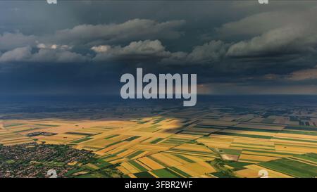 Agricultural fields under dramatic dark storm clouds Stock Photo