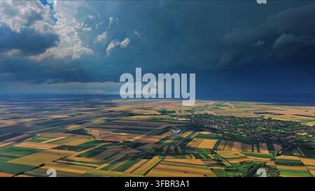 Agricultural fields under dramatic dark storm clouds Stock Photo