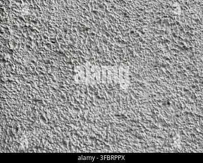 Textured gray roughcast plaster house wall Stock Photo