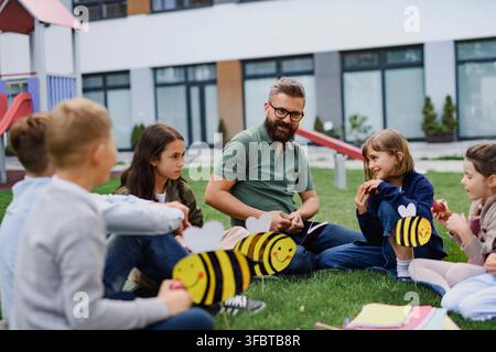 Students exploring ecology and biodiversity during outdoor class at school. Stock Photo