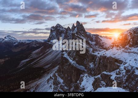 Sunrise over Seceda after fresh snowfall in the Dolomites. Mountain landscape with colorful clouds, rugged limestone peaks and winter conditions Stock Photo