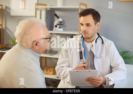 Senior nursing, health and social care of elderly people, young doctor, male geriatric nurse helping Stock Photo
