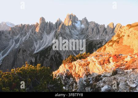 Cadini di Misurina mountain range illuminated by warm sunrise light in the Dolomites. Jagged limestone peaks and rugged alpine terrain in northern Italy Stock Photo