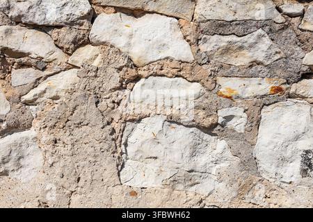 Rustic white stone wall texture with rough mortar joints Stock Photo