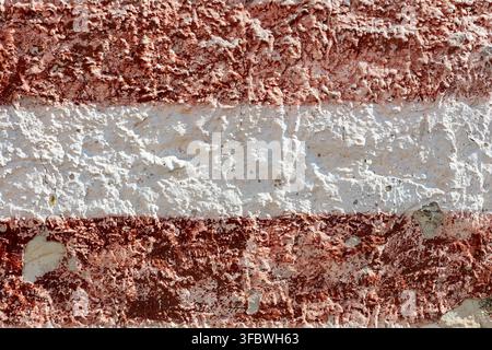Weathered red and white striped wall texture background Stock Photo