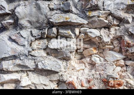Rugged gray stone wall texture with rock blocks Stock Photo