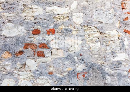 Old wall texture with exposed brick and crumbling plaster Stock Photo