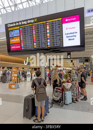 Busy bank-holiday check-in and bag-drop area in Terminal 2 at Manchester Airport, England, UK. Stock Photo