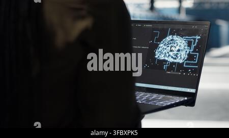 Data center computer scientist doing AI data analysis on laptop to upgrade infrastructure. Server room IT specialist using notebook to manage storage systems for neural networks datasets Stock Photo
