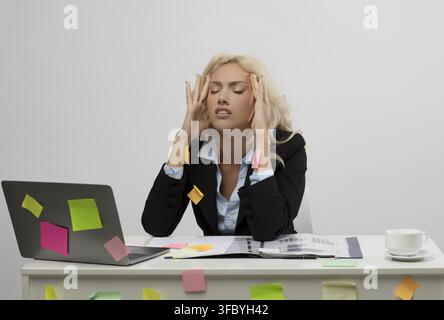 Stressed Young Caucasian Woman Holding Head With Frustration At Office, Business Concept Stock Photo