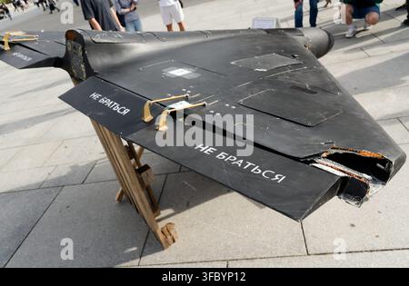 Detailed view of the damaged wing of a shot-down black Shahed kamikaze drone with Cyrillic safety text reading 'Do Not Touch'. Stock Photo