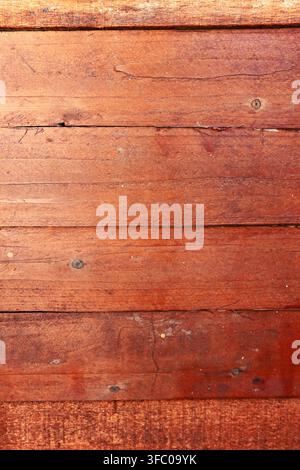 Horizontal reddish-brown wooden planks showing natural grain, knots, and weathered surface textures Stock Photo