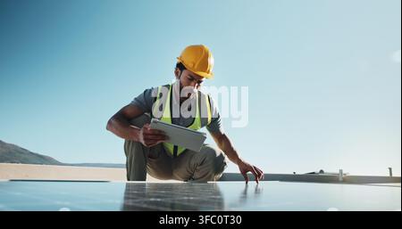 Man, technician and solar panels outdoor with tablet, research and inspection for fault detection. Space, electrician and monitor pv grid with tech Stock Photo