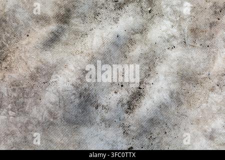 A close-up shot capturing the weathered, mottled texture of a light grey industrial cloth. Excellent as an abstract background, graphic design texture Stock Photo